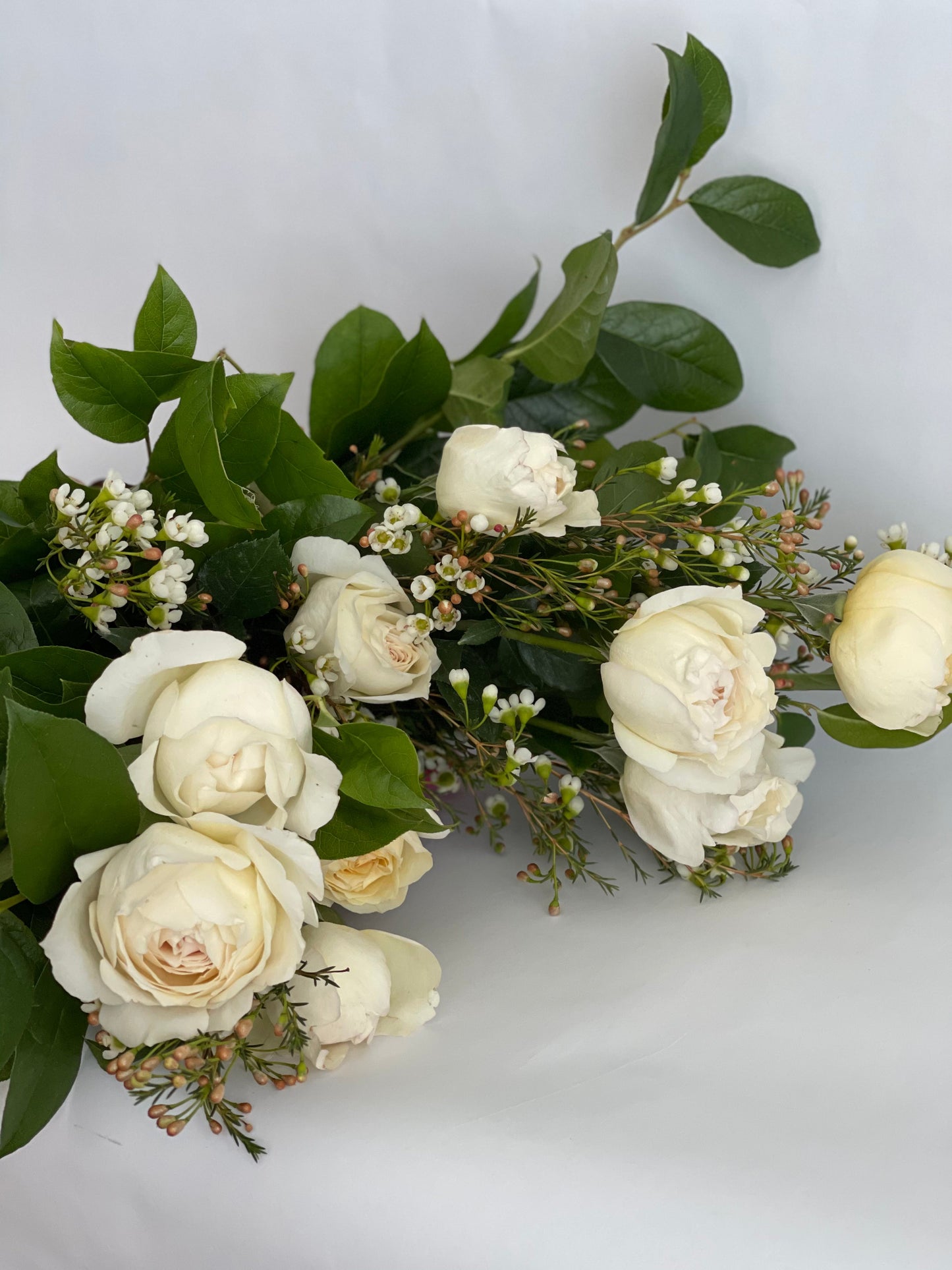 White Roses wrapped bouquet from Luminous Blooms in Highland Park